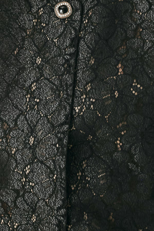 A woman wearing a black lace short-sleeve cropped top with a single button closure | FREEMARKET