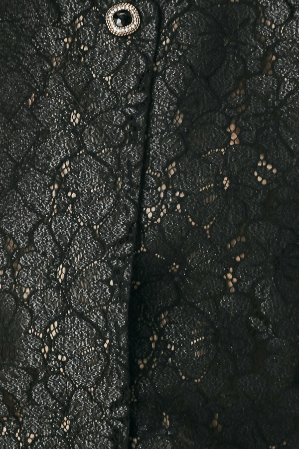 A woman wearing a black lace short-sleeve cropped top with a single button closure | FREEMARKET