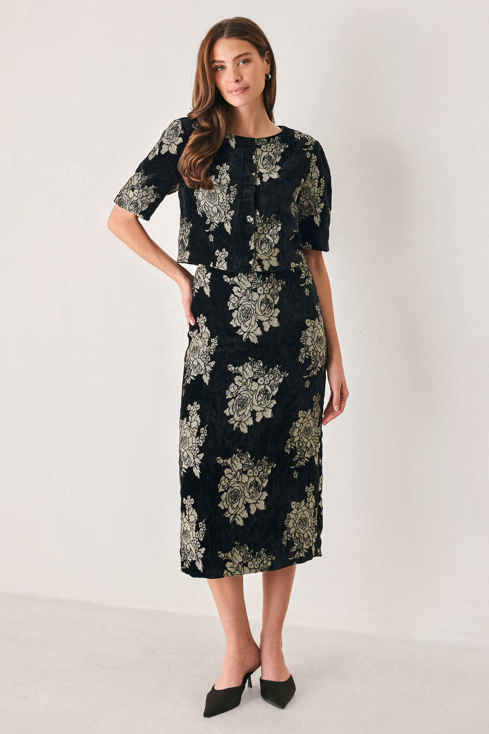 Woman wearing a black short sleeve cropped top/jacket with jacquard flowers | FREEMARKET