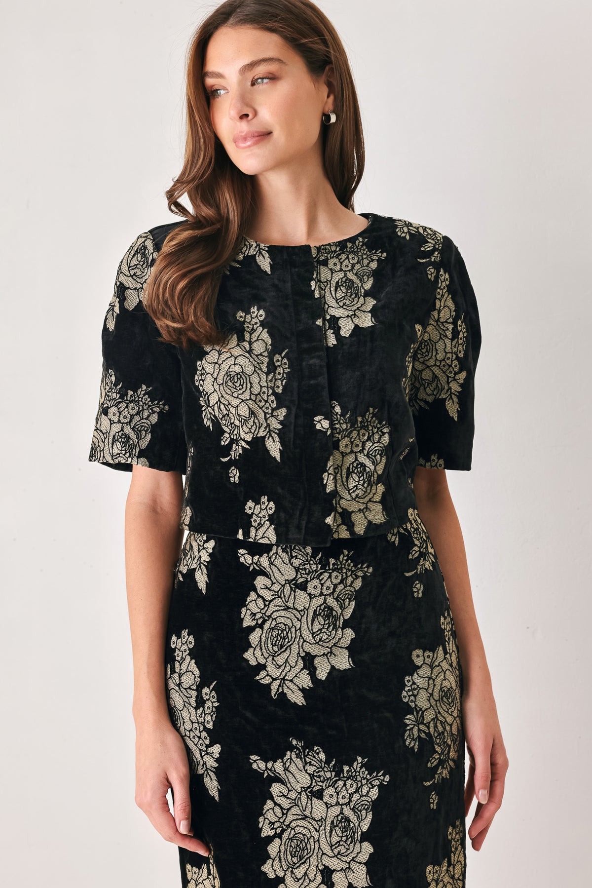 Woman wearing a black short sleeve cropped top/jacket with jacquard flowers | FREEMARKET