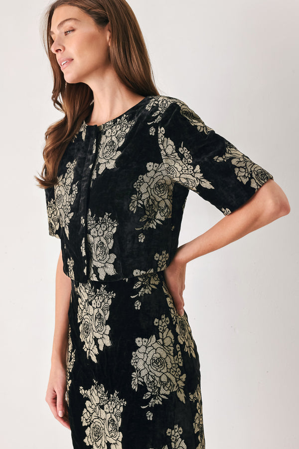 Woman wearing a black short sleeve cropped top/jacket with jacquard flowers | FREEMARKET