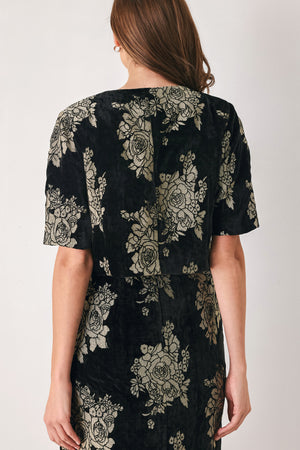 Woman wearing a black short sleeve cropped top/jacket with jacquard flowers | FREEMARKET