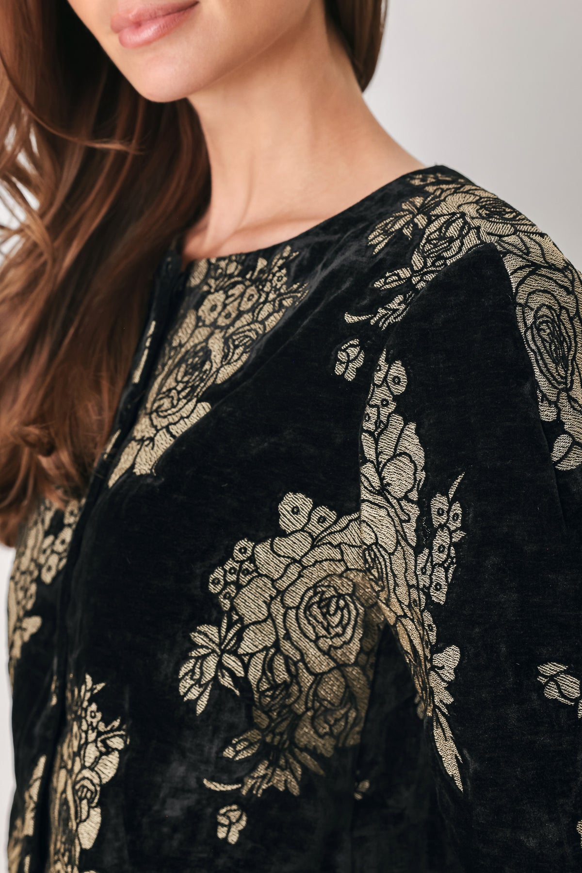 Woman wearing a black short sleeve cropped top/jacket with jacquard flowers | FREEMARKET