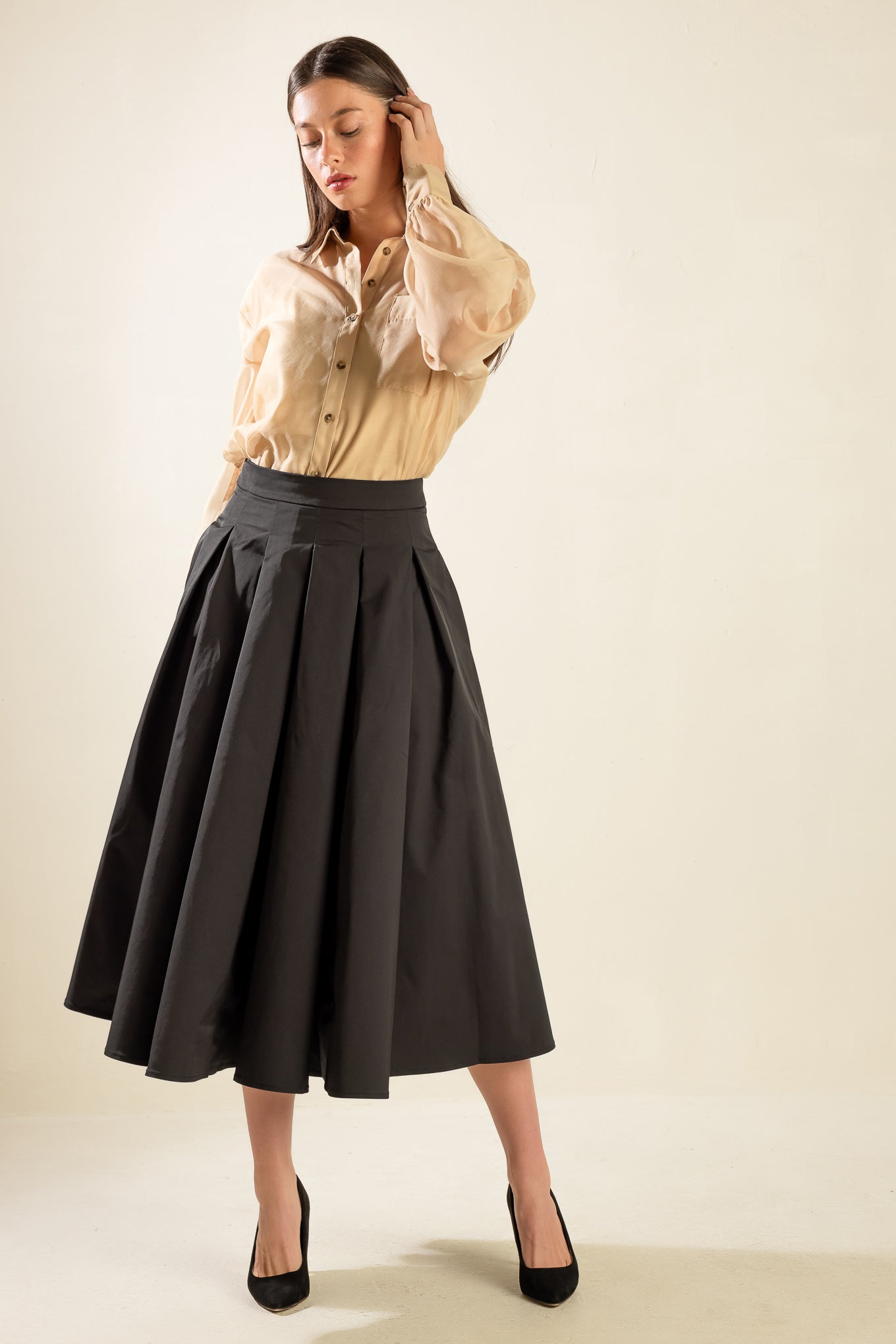 A solid woven full skirt with back zipper closure