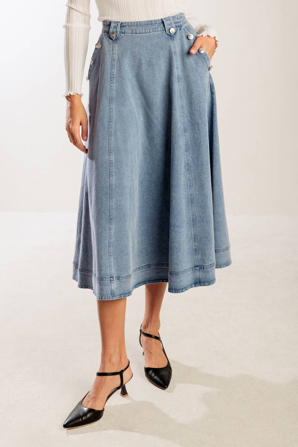 A washed denim skirt featuring button detail, A line and back zipper closure