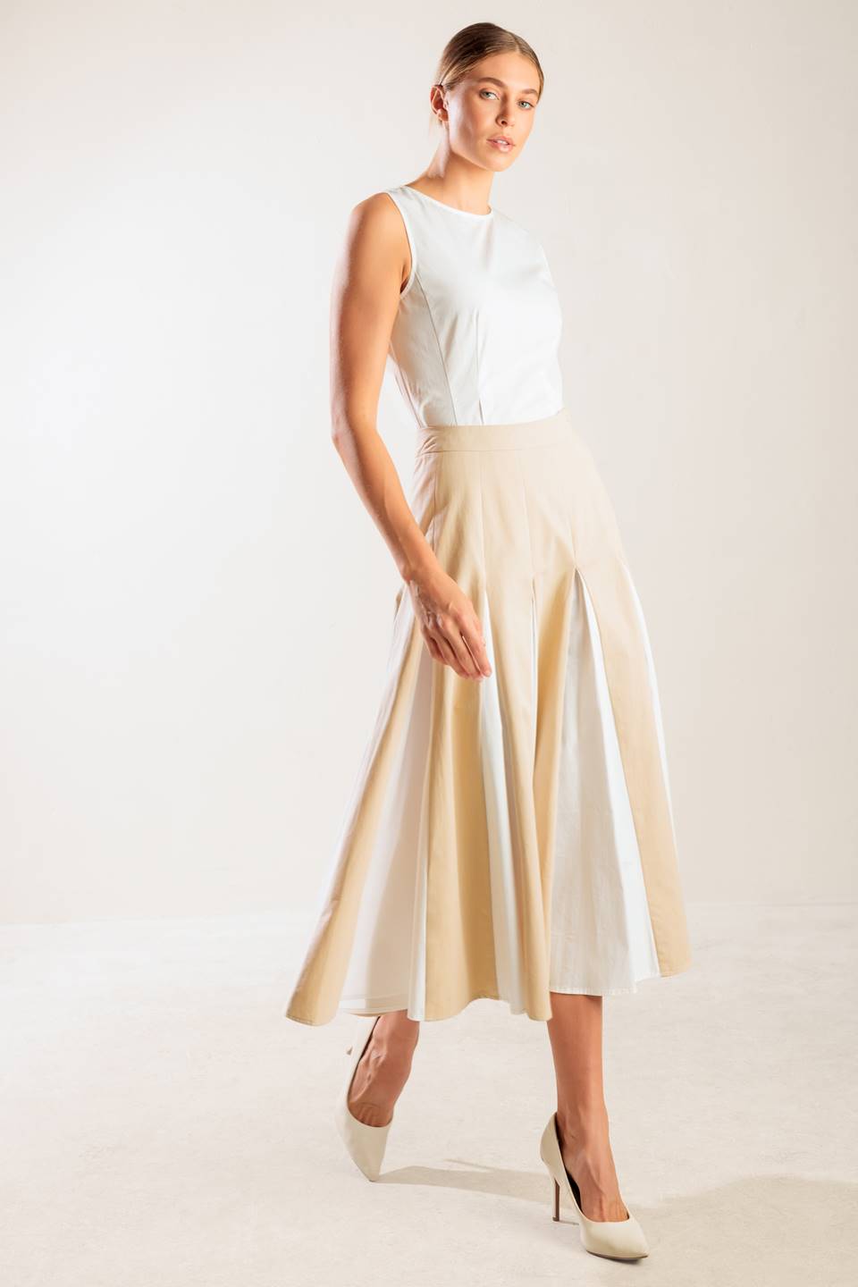 A solid woven midi skirt with side zipper and color blocked