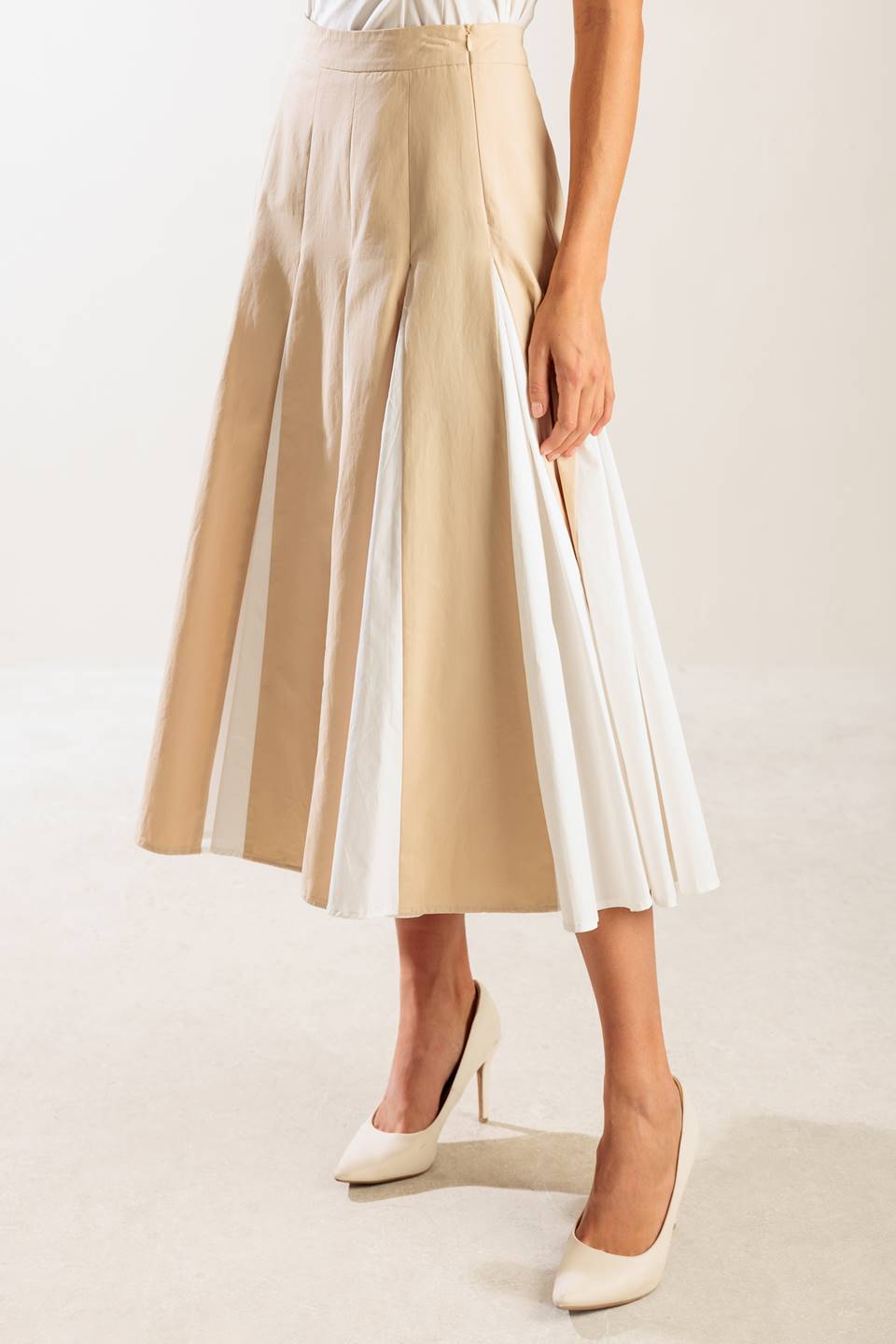 A solid woven midi skirt with side zipper and color blocked