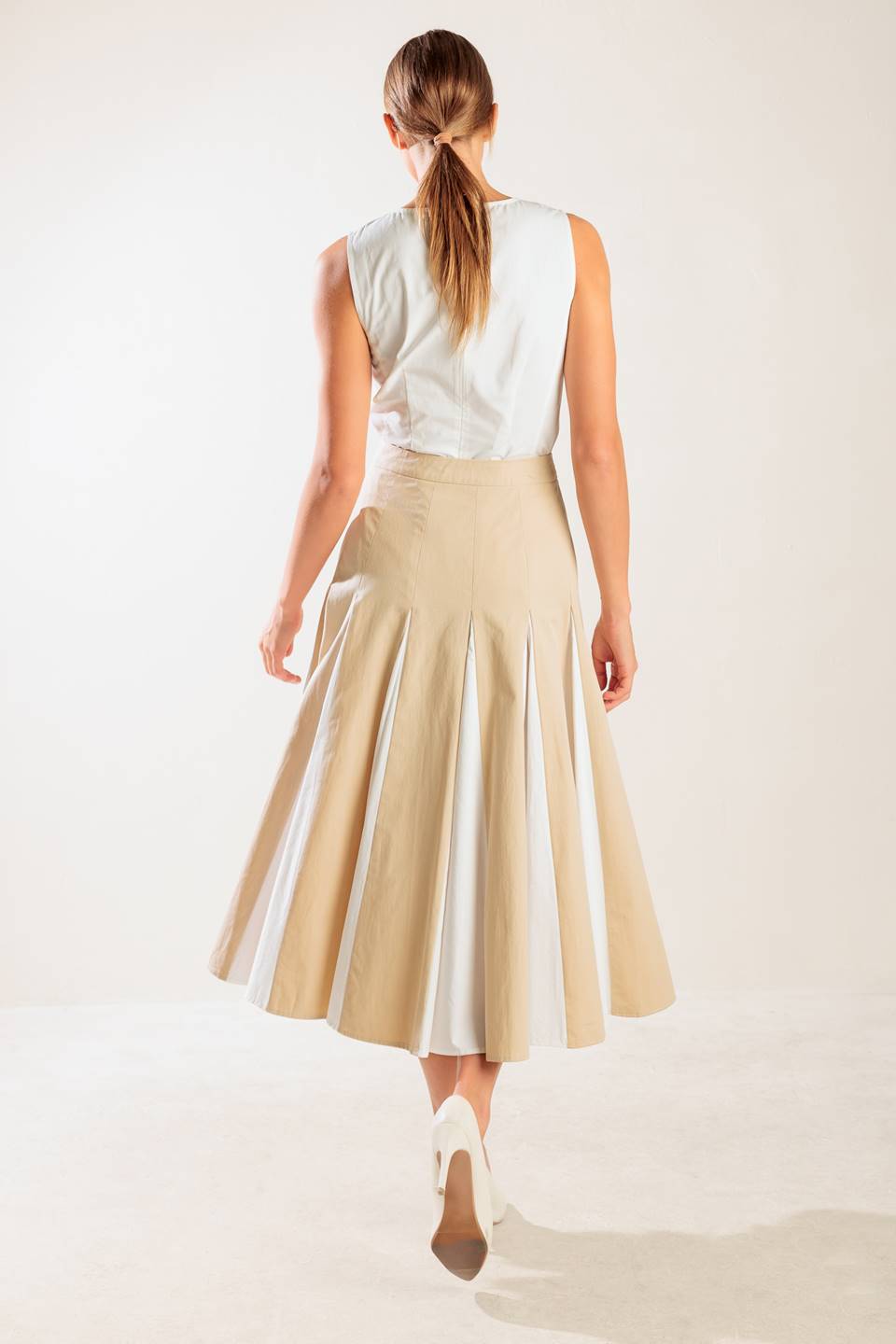 A solid woven midi skirt with side zipper and color blocked