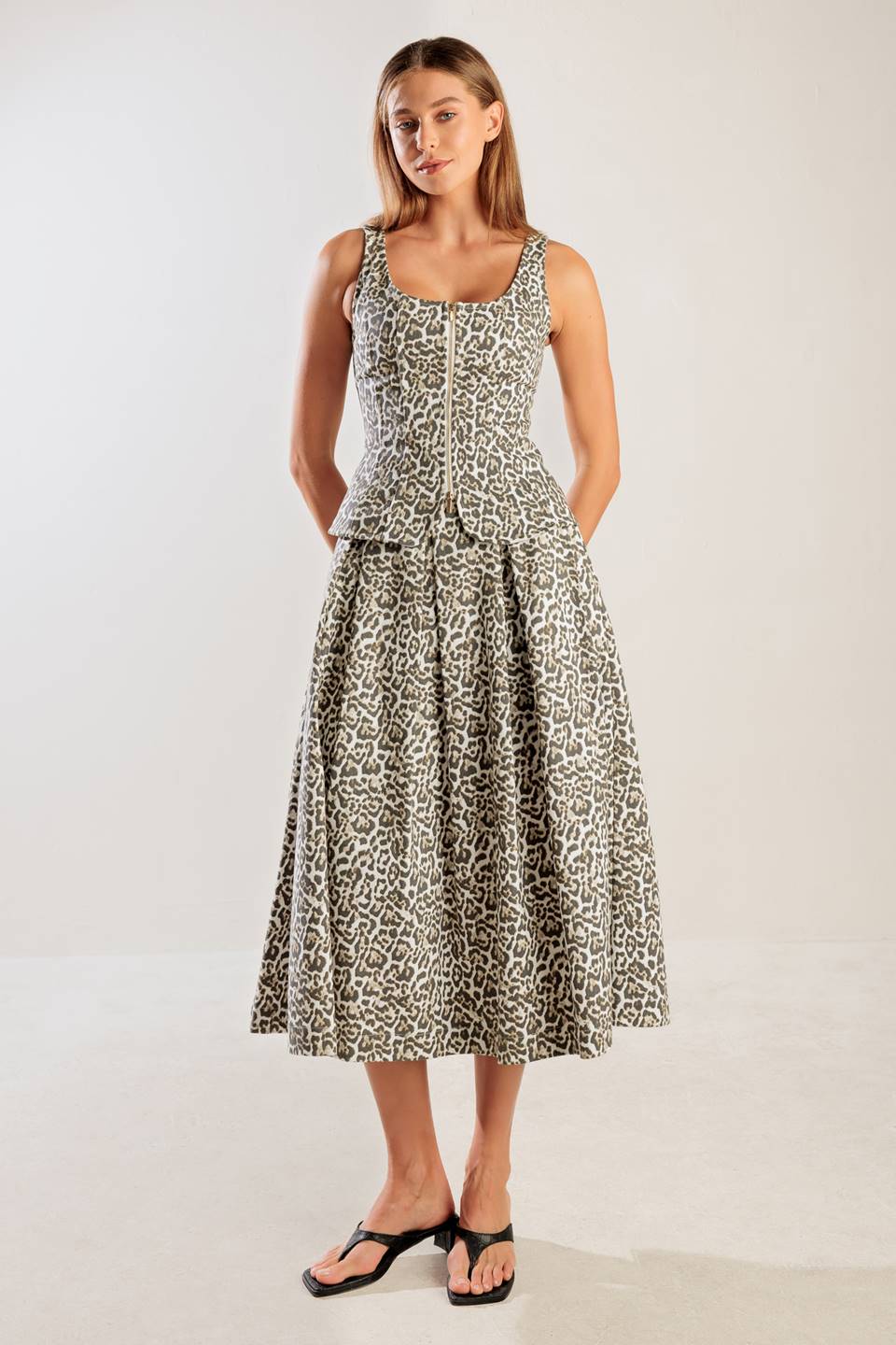 A leopard printed, woven midi full skirt a side zipper closure.