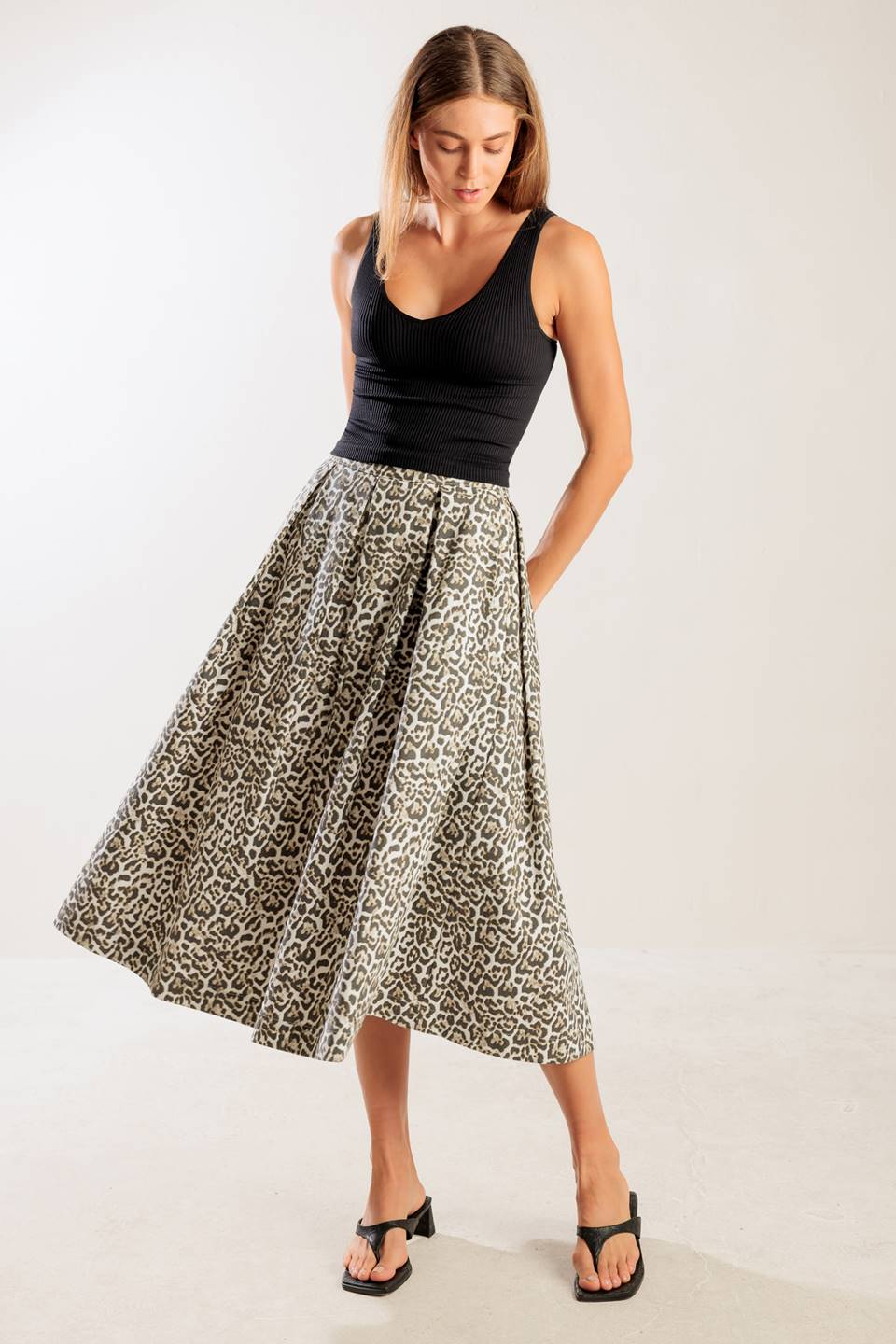 A leopard printed, woven midi full skirt a side zipper closure.