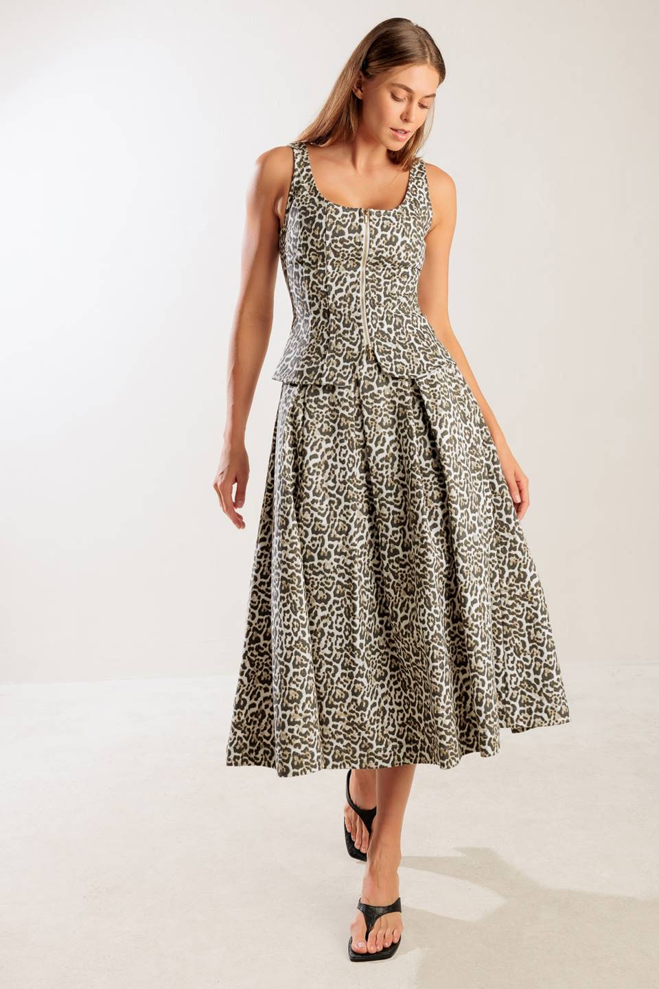 A leopard printed, woven midi full skirt a side zipper closure.