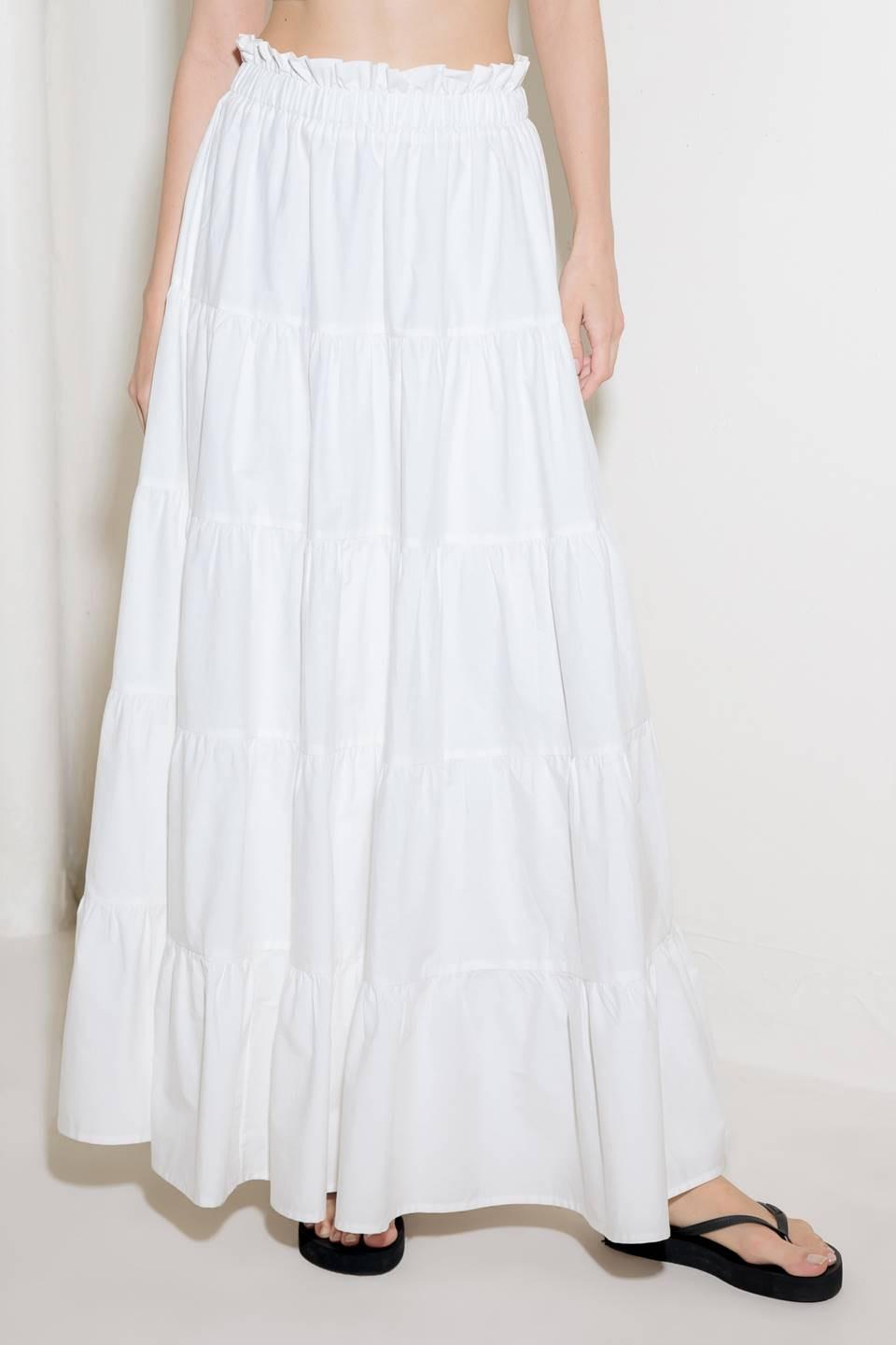 A woven maxi skirt featuring an elasticized waist and tiers.