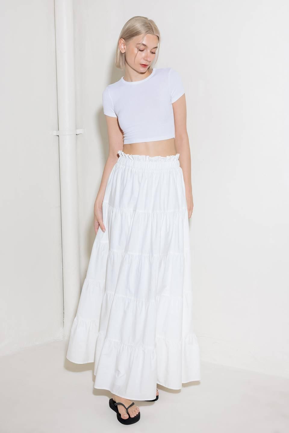 A woven maxi skirt featuring an elasticized waist and tiers.
