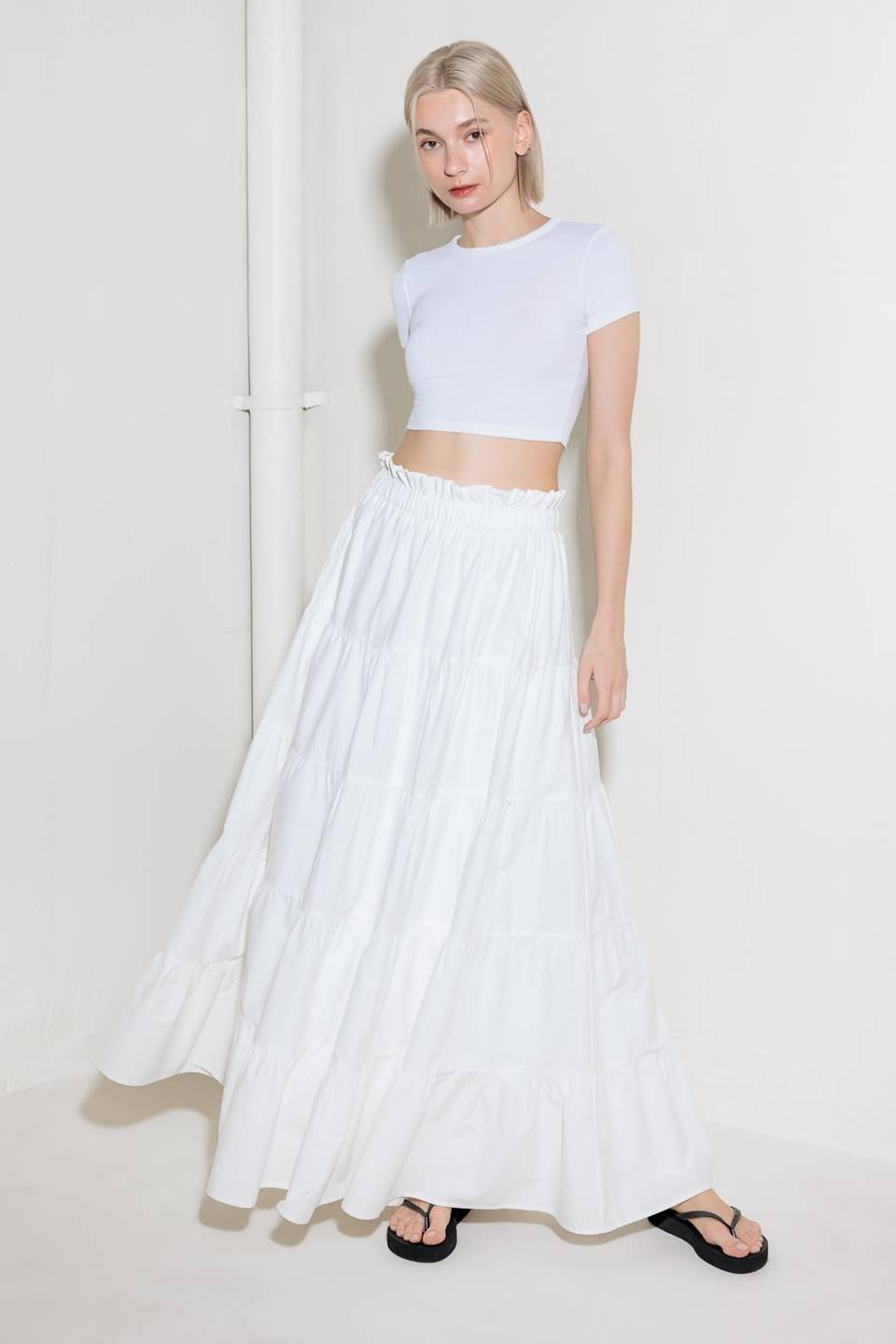 A woven maxi skirt featuring an elasticized waist and tiers.