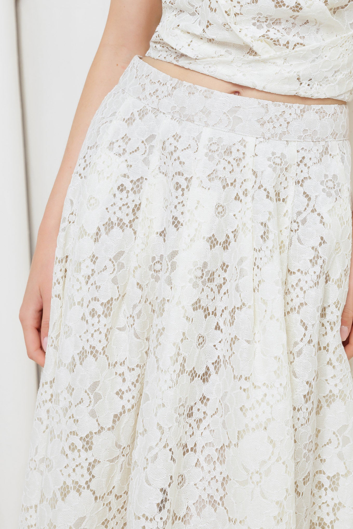 A woven lace midi skirt with back zipper closure.