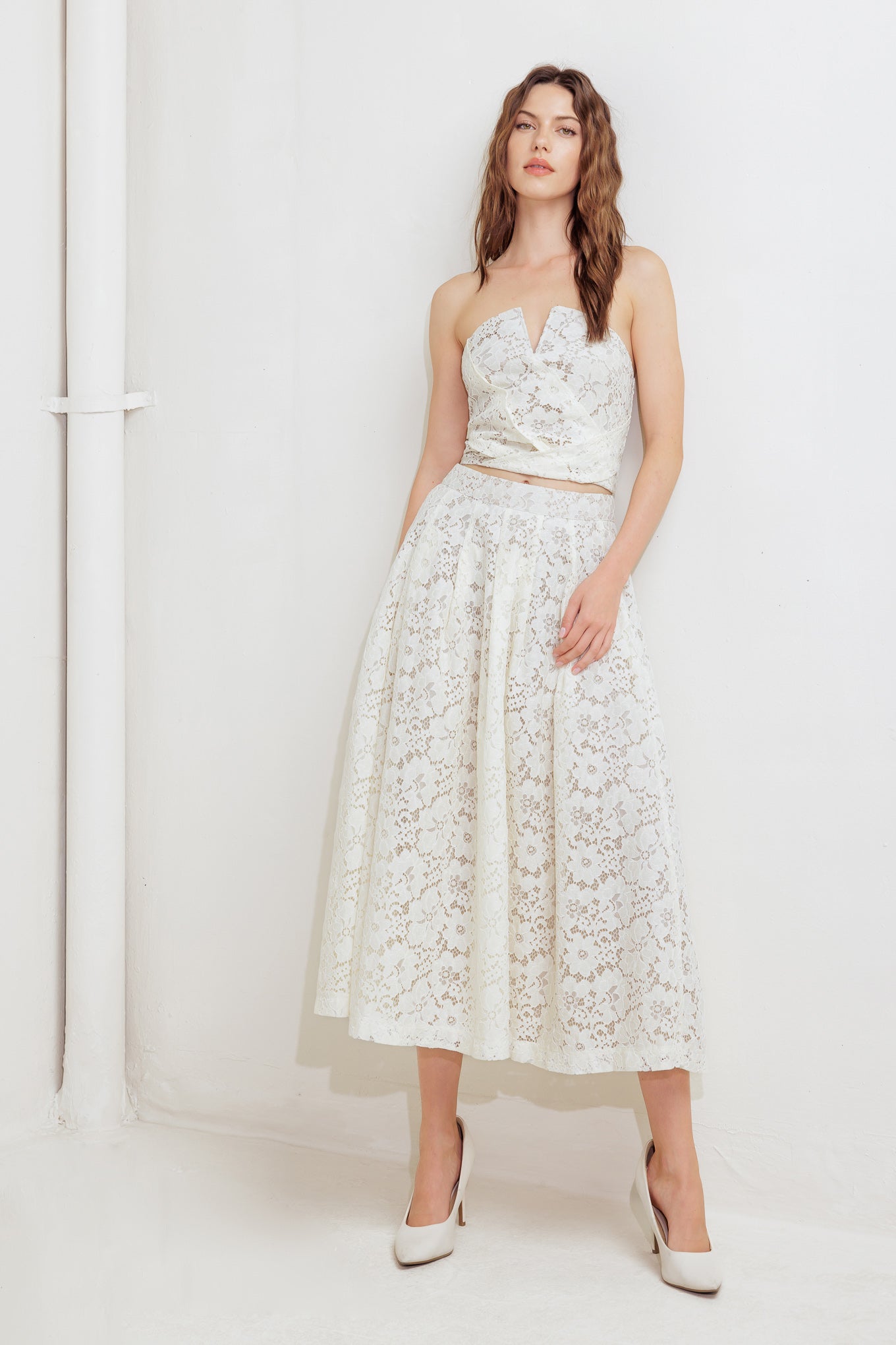 A woven lace midi skirt with back zipper closure.