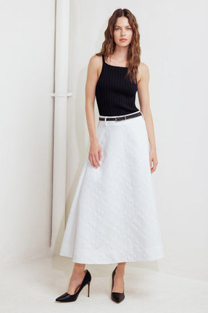 A white, textured woven midi skirt featuring a contrasting belt and back zipper closure
