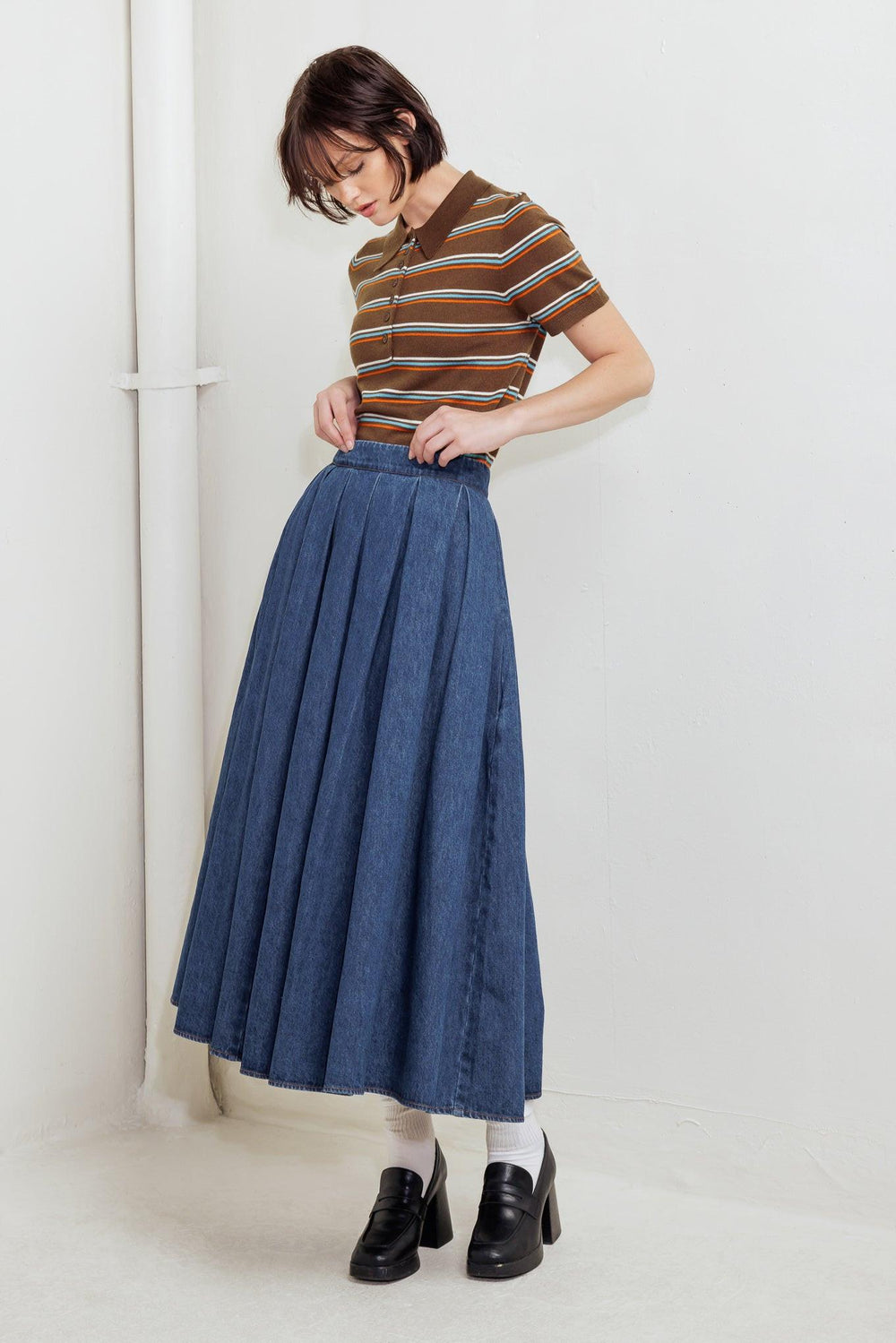 A washed denim full skirt with back zipper closure
