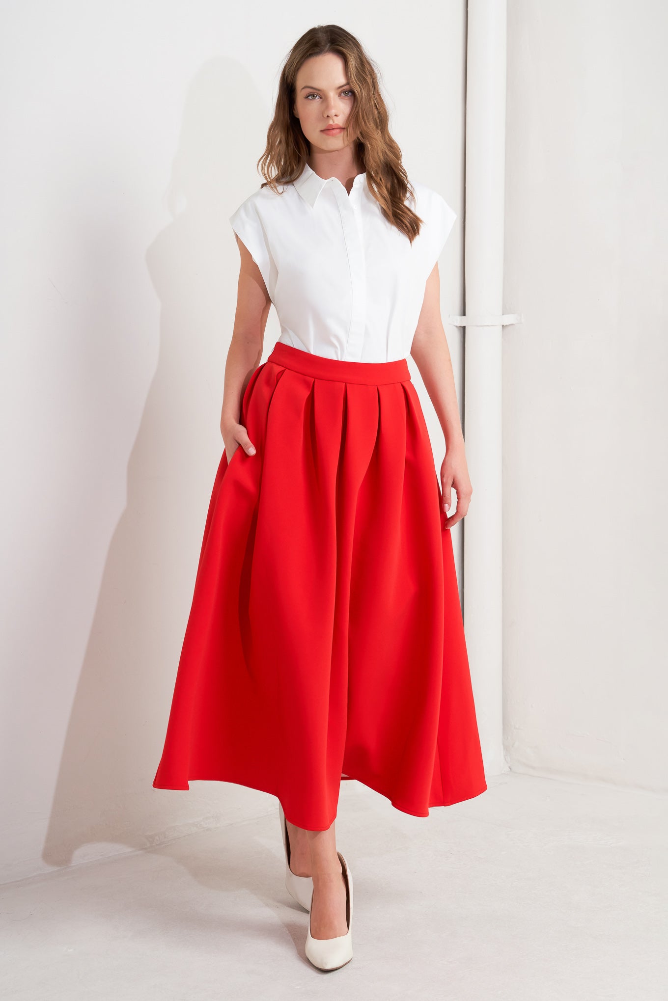 A solid red woven full midi skirt with back zipper closure