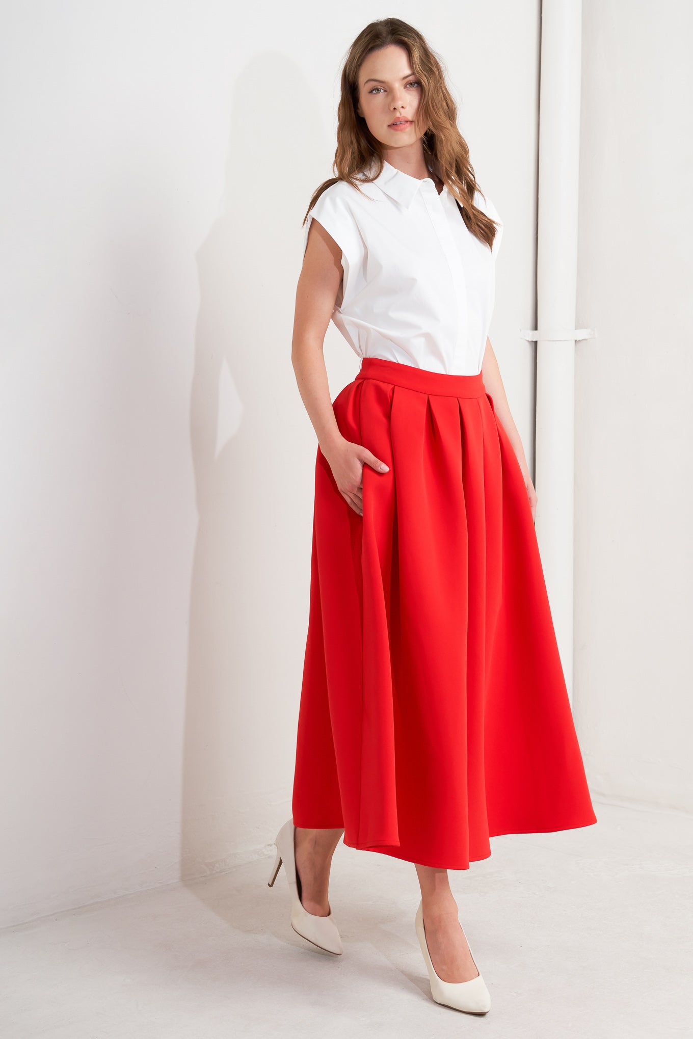 A solid red woven full midi skirt with back zipper closure