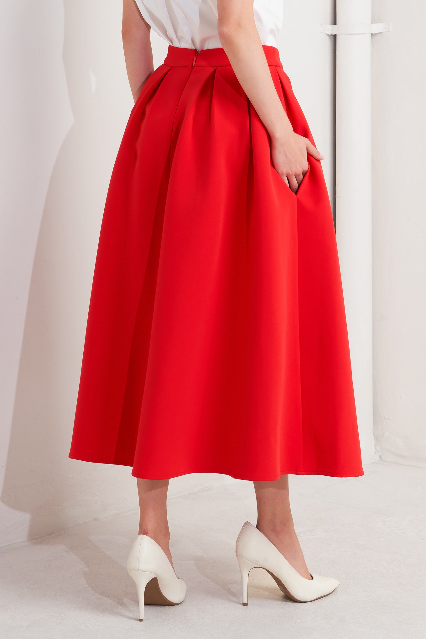 A solid red woven full midi skirt with back zipper closure