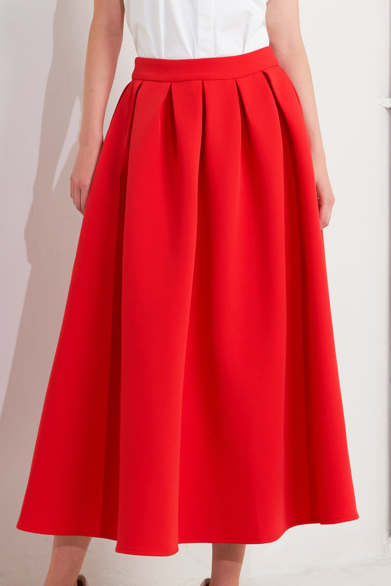 A solid red woven full midi skirt with back zipper closure