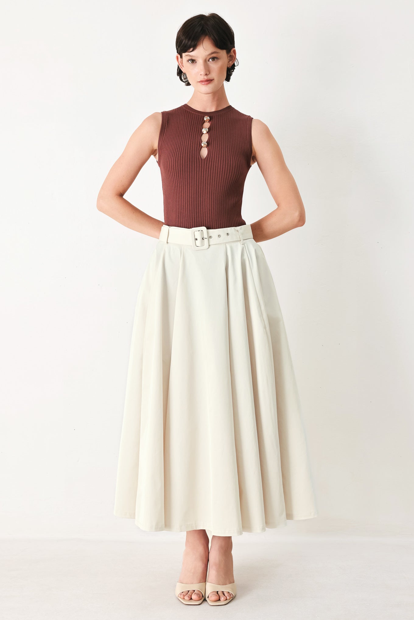 Woman wearing a white full midi skirt featuring self belt and side zipper closure | FREEMARKET