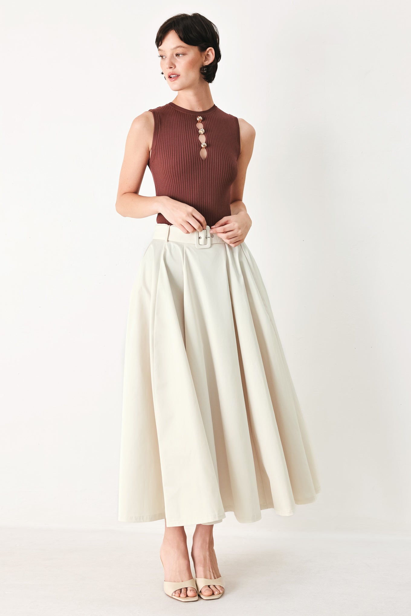 Woman wearing a white full midi skirt featuring self belt and side zipper closure | FREEMARKET