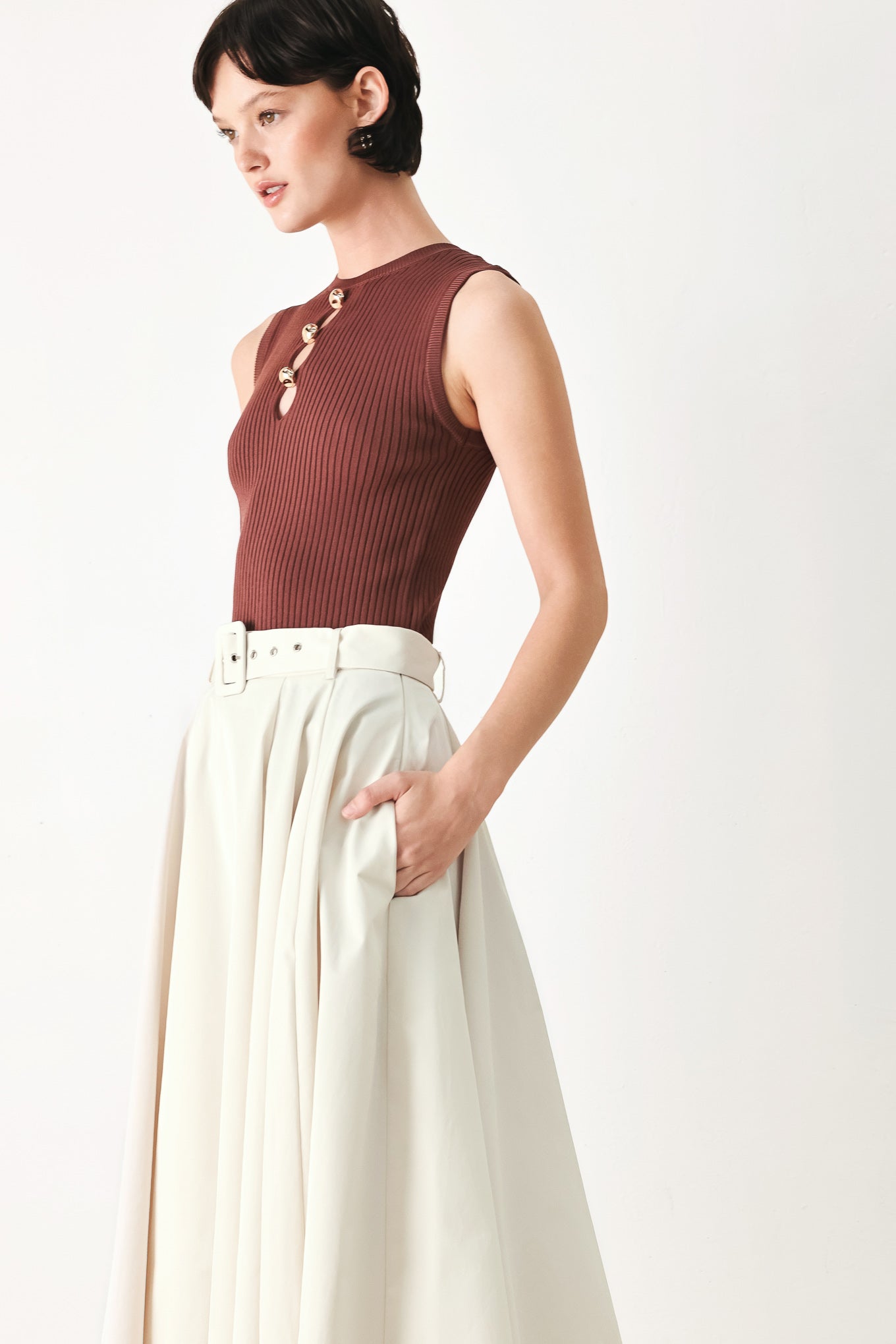Woman wearing a white full midi skirt featuring self belt and side zipper closure | FREEMARKET