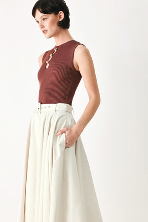 Woman wearing a white full midi skirt featuring self belt and side zipper closure | FREEMARKET