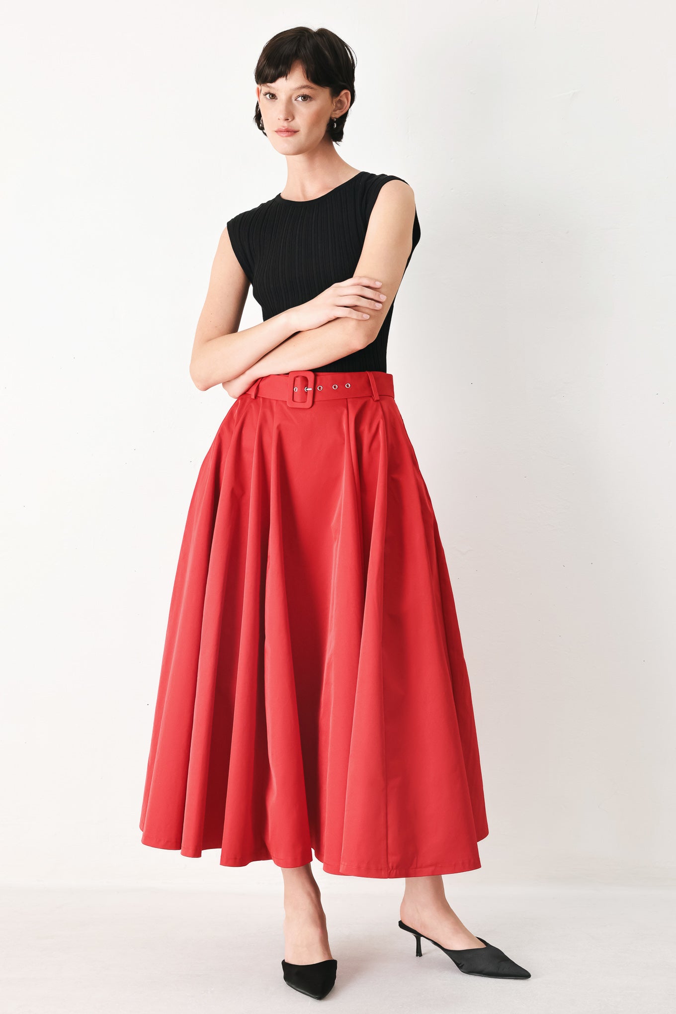 Woman wearing a red full midi skirt featuring self belt and side zipper closure | FREEMARKET