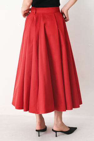 Woman wearing a red full midi skirt featuring self belt and side zipper closure | FREEMARKET