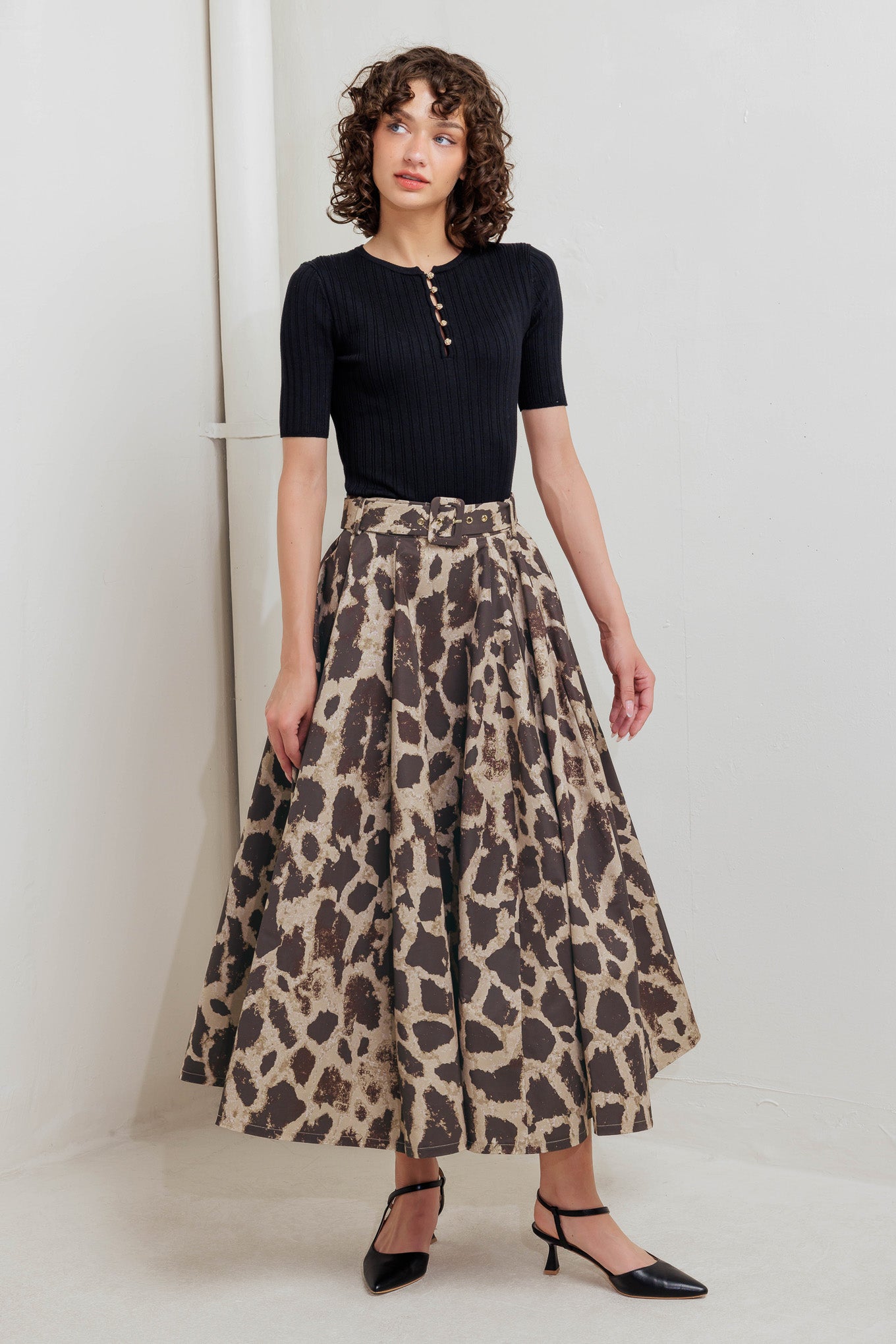 A printed woven full midi skirt featuring self belt, side pockets and zipper closure