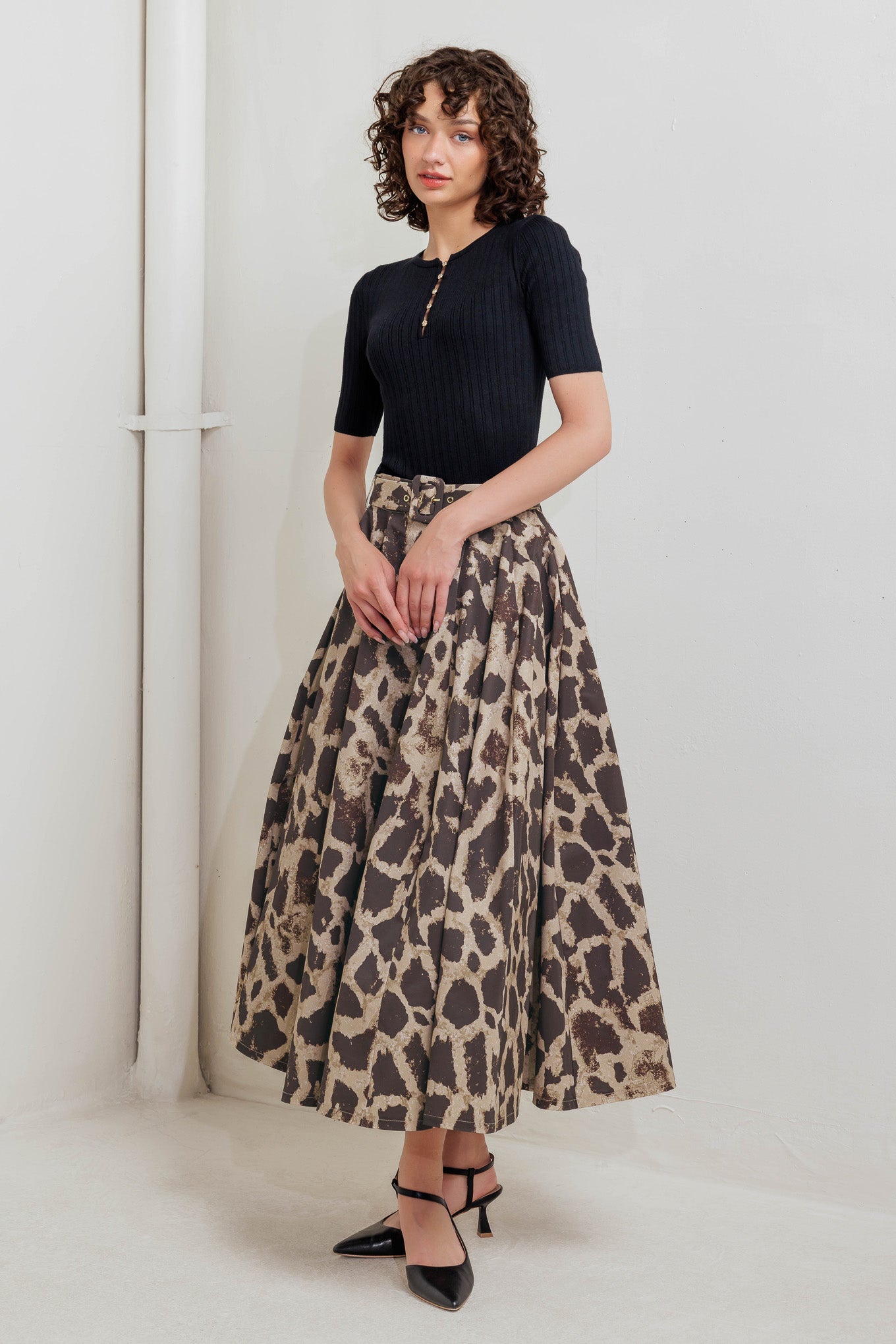 A printed woven full midi skirt featuring self belt, side pockets and zipper closure