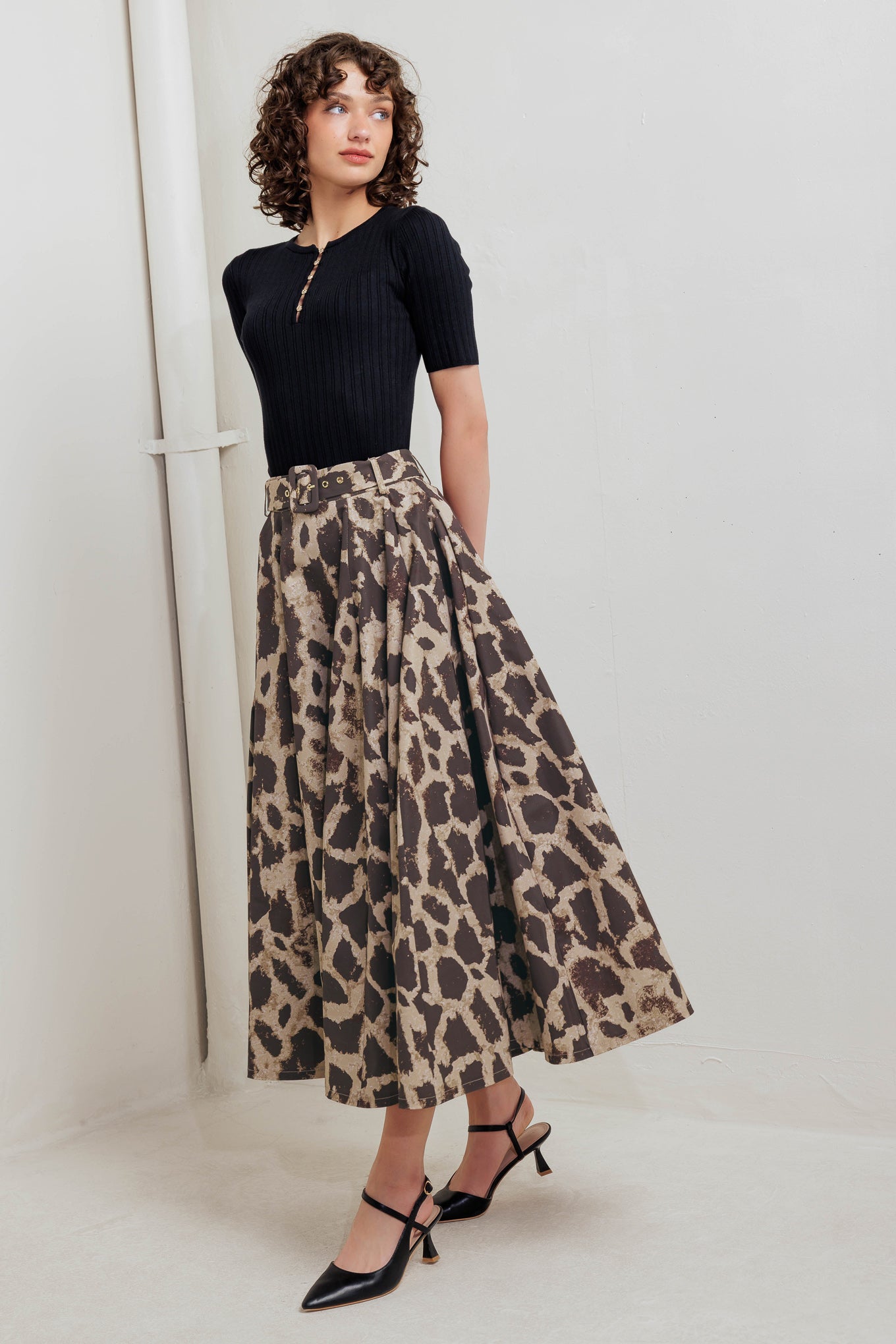 A printed woven full midi skirt featuring self belt, side pockets and zipper closure