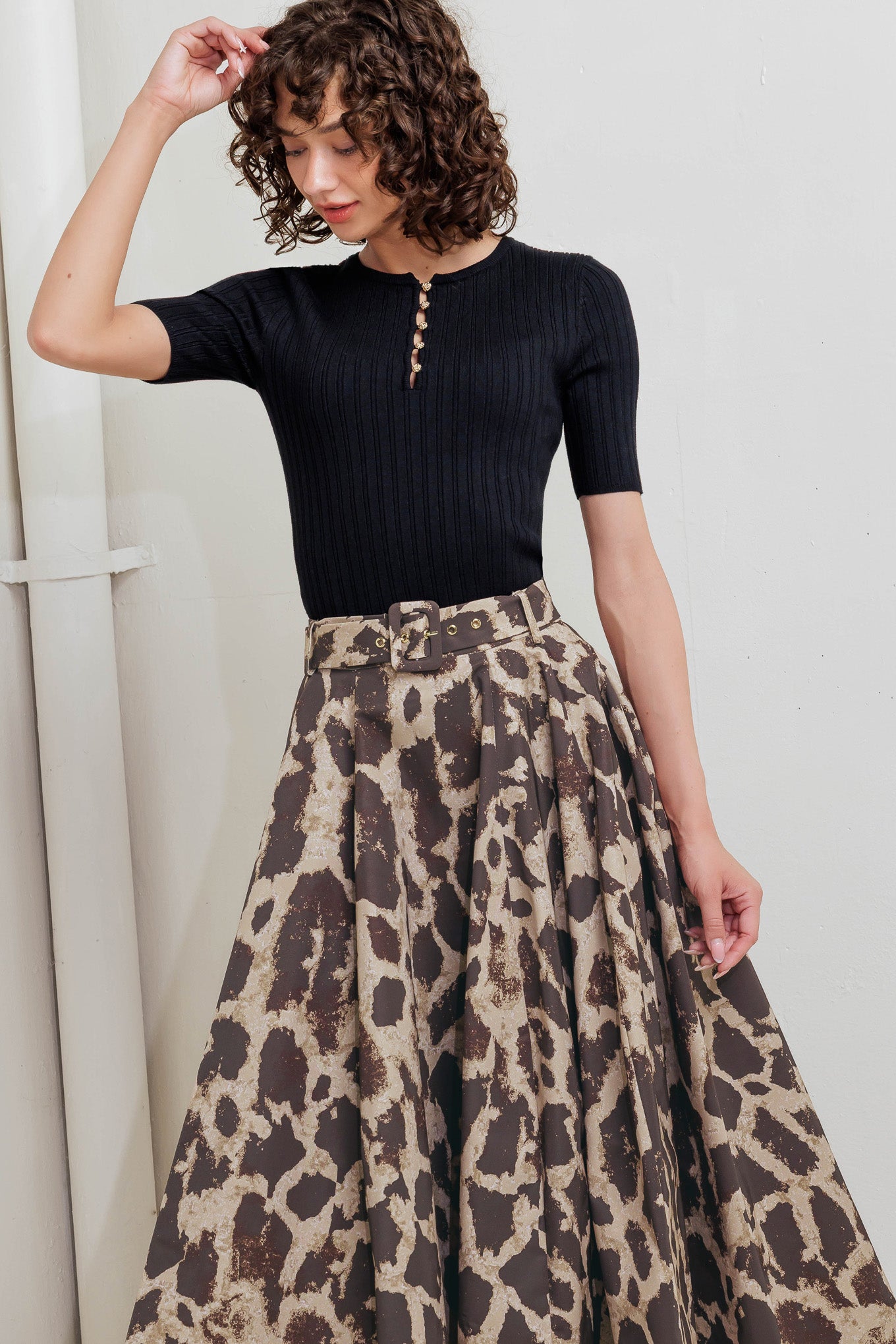 A printed woven full midi skirt featuring self belt, side pockets and zipper closure