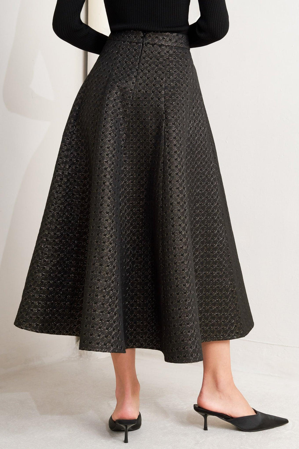A textured metallic threaded woven circle skirt with back zipper closure.