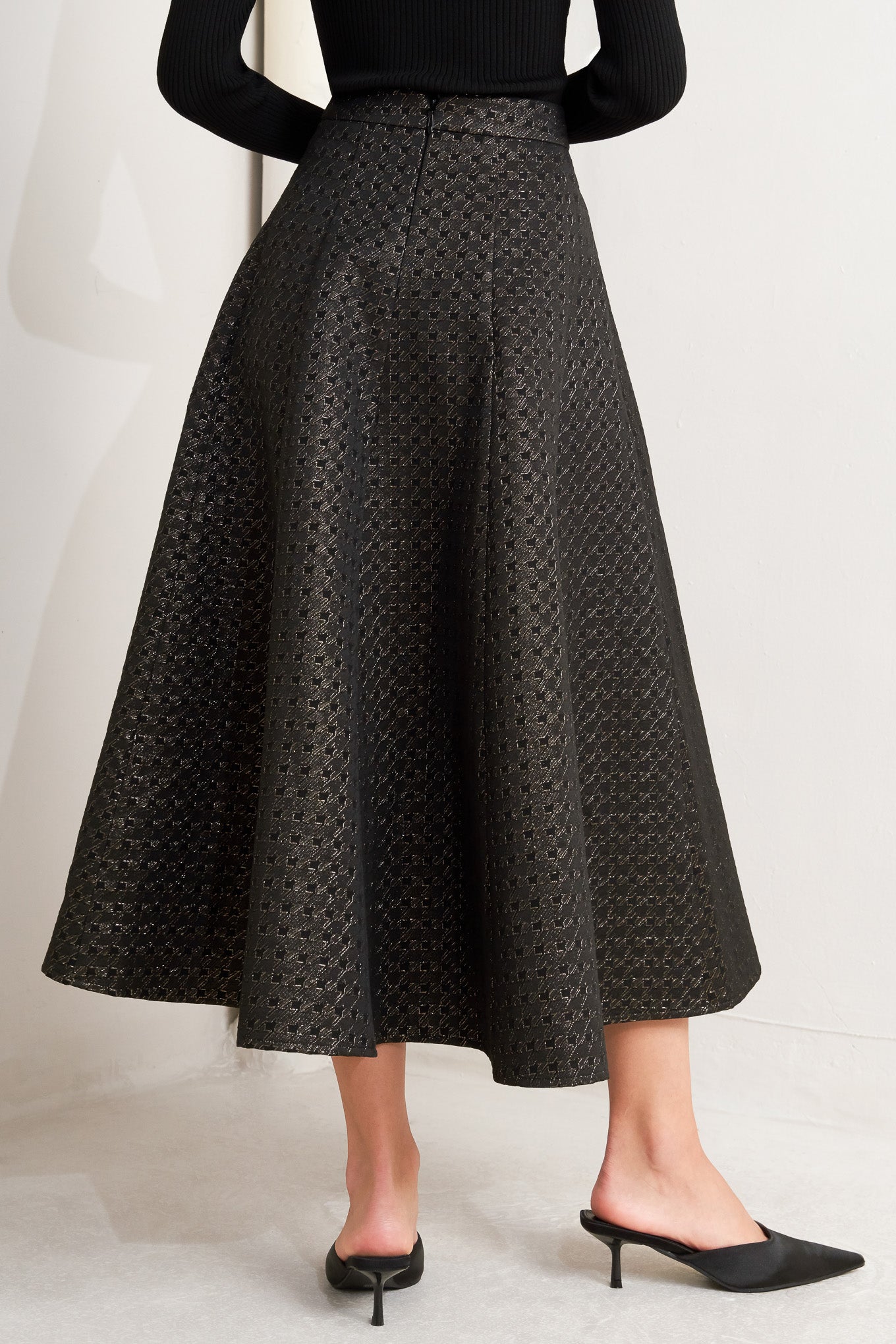 A textured metallic threaded woven circle skirt with back zipper closure.