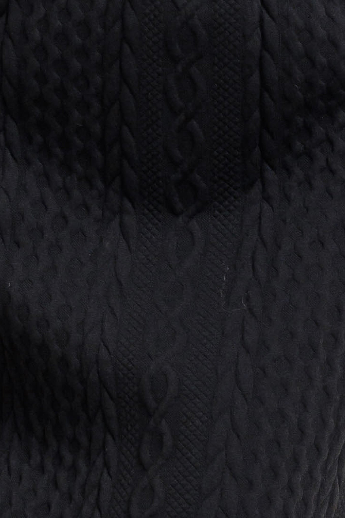 A knit midi skirt featuring elasticized waistband and side button detail. 