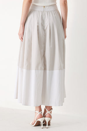 Woman wearing a taupe and white striped woven midi skirt with front button detail, box pleats and back zipper closure | FREEMARKET