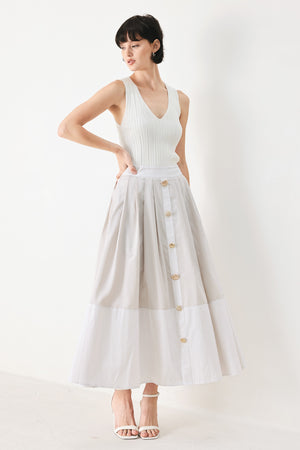 Woman wearing a taupe and white striped woven midi skirt with front button detail, box pleats and back zipper closure | FREEMARKET