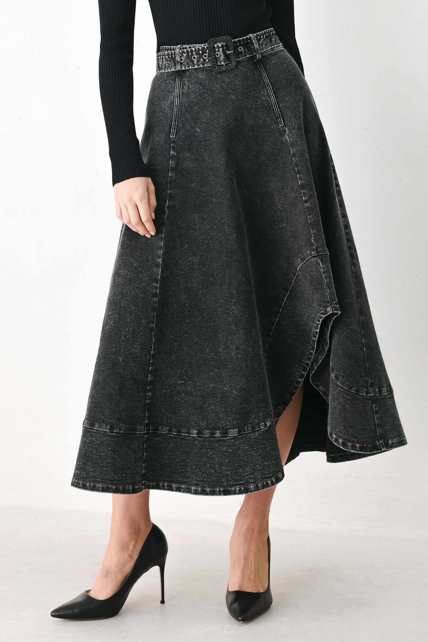 A model wearing a high-waisted, dark gray washed denim midi skirt with a decorative studded belt | FREEMARKET