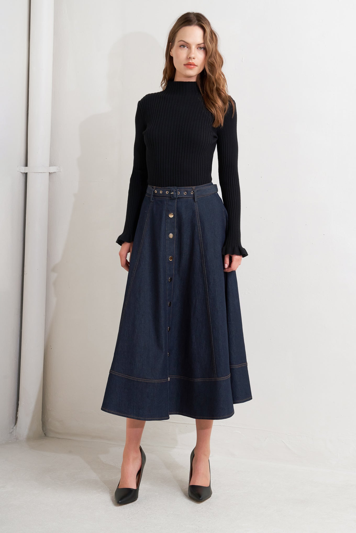 A denim circle skirt featuring self belt, front button down and wide hemline