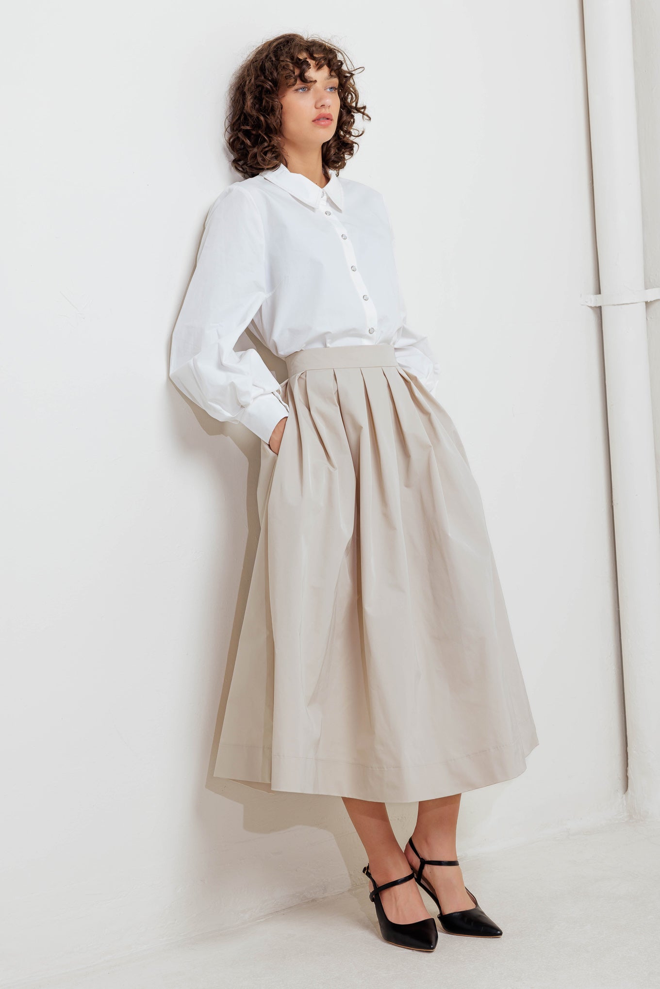 A solid woven full midi skirt with back zipper closure