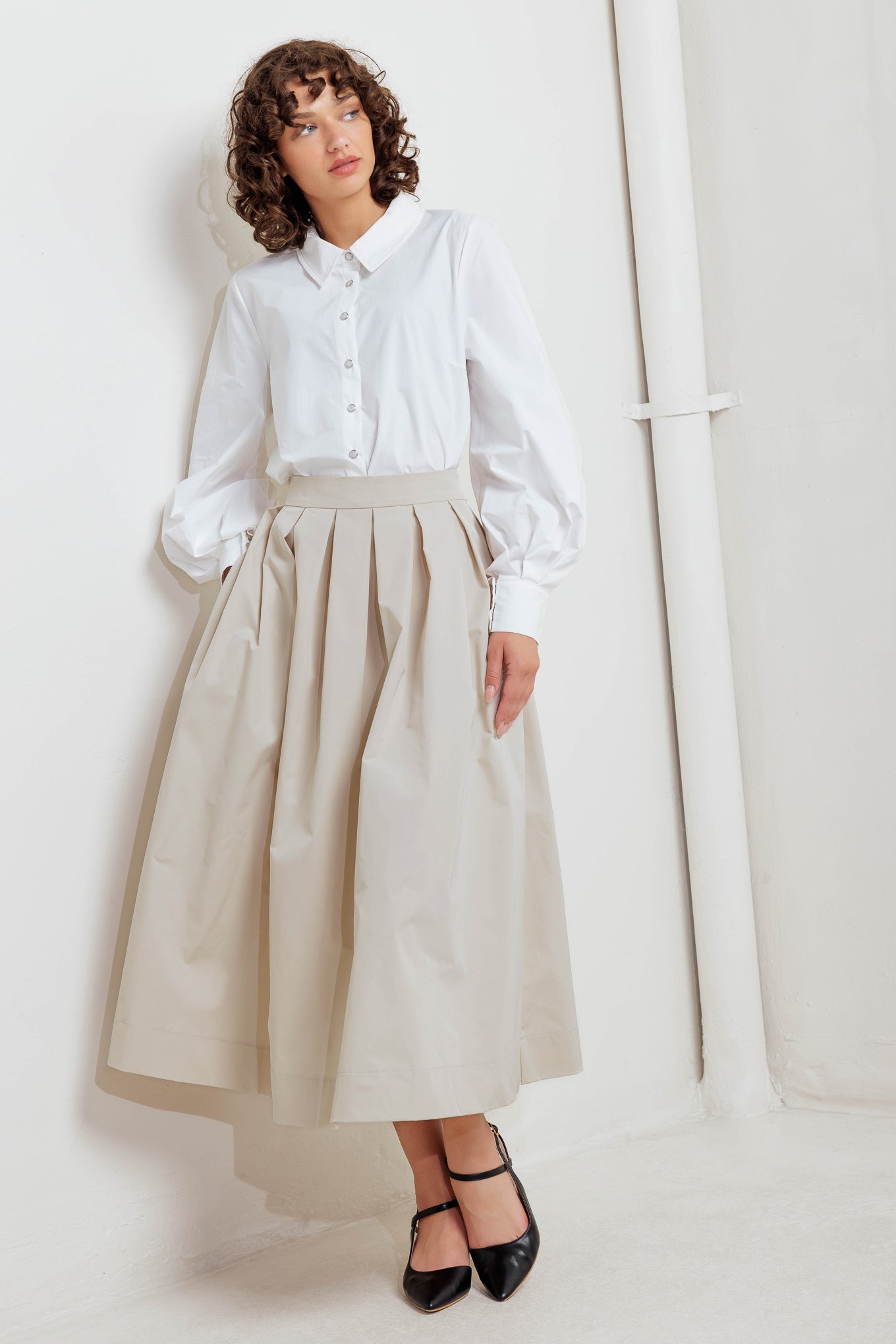 A solid woven full midi skirt with back zipper closure