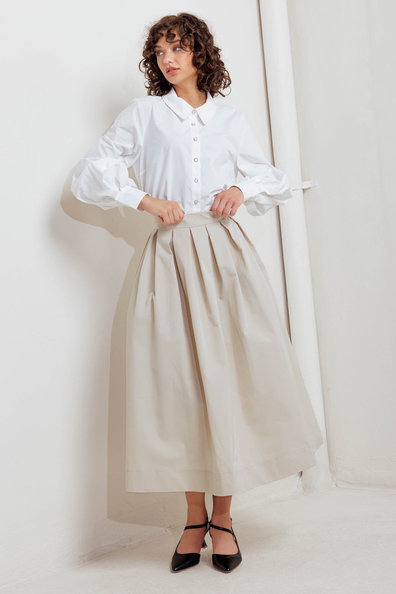 A solid woven full midi skirt with back zipper closure