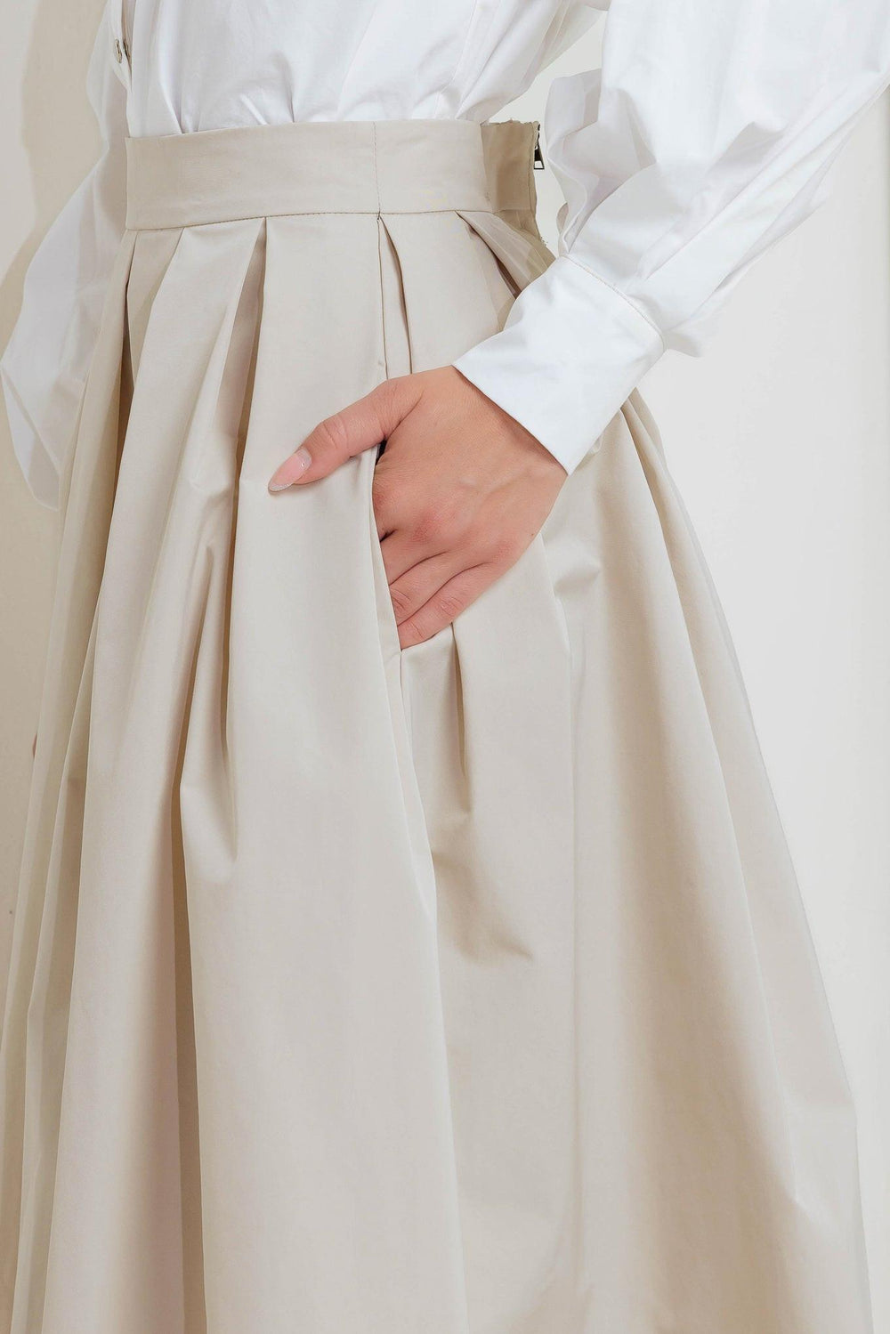 A solid woven full midi skirt with back zipper closure
