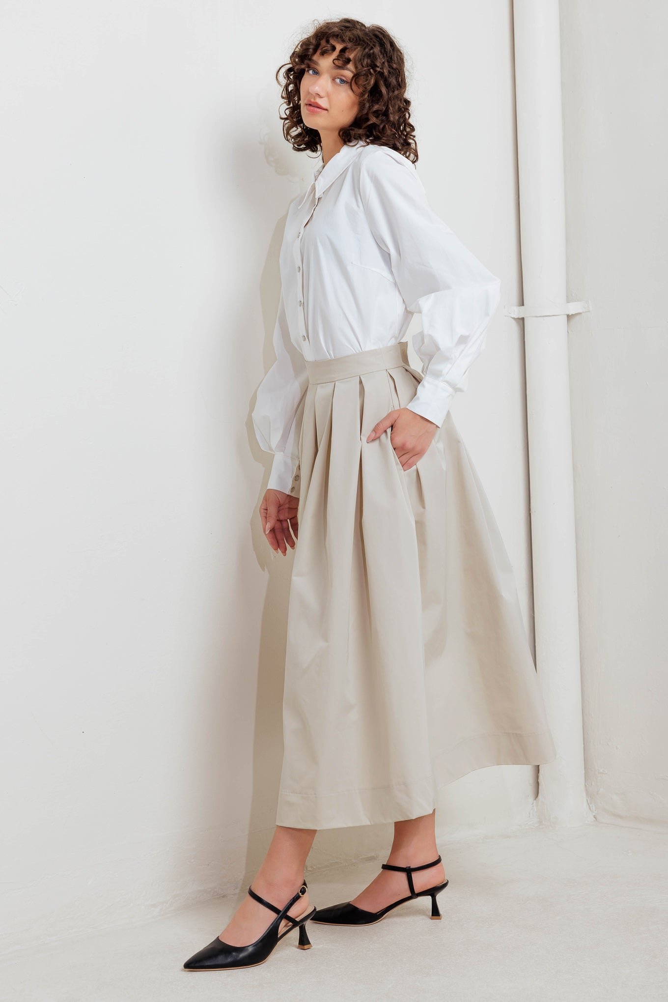 A solid woven full midi skirt with back zipper closure