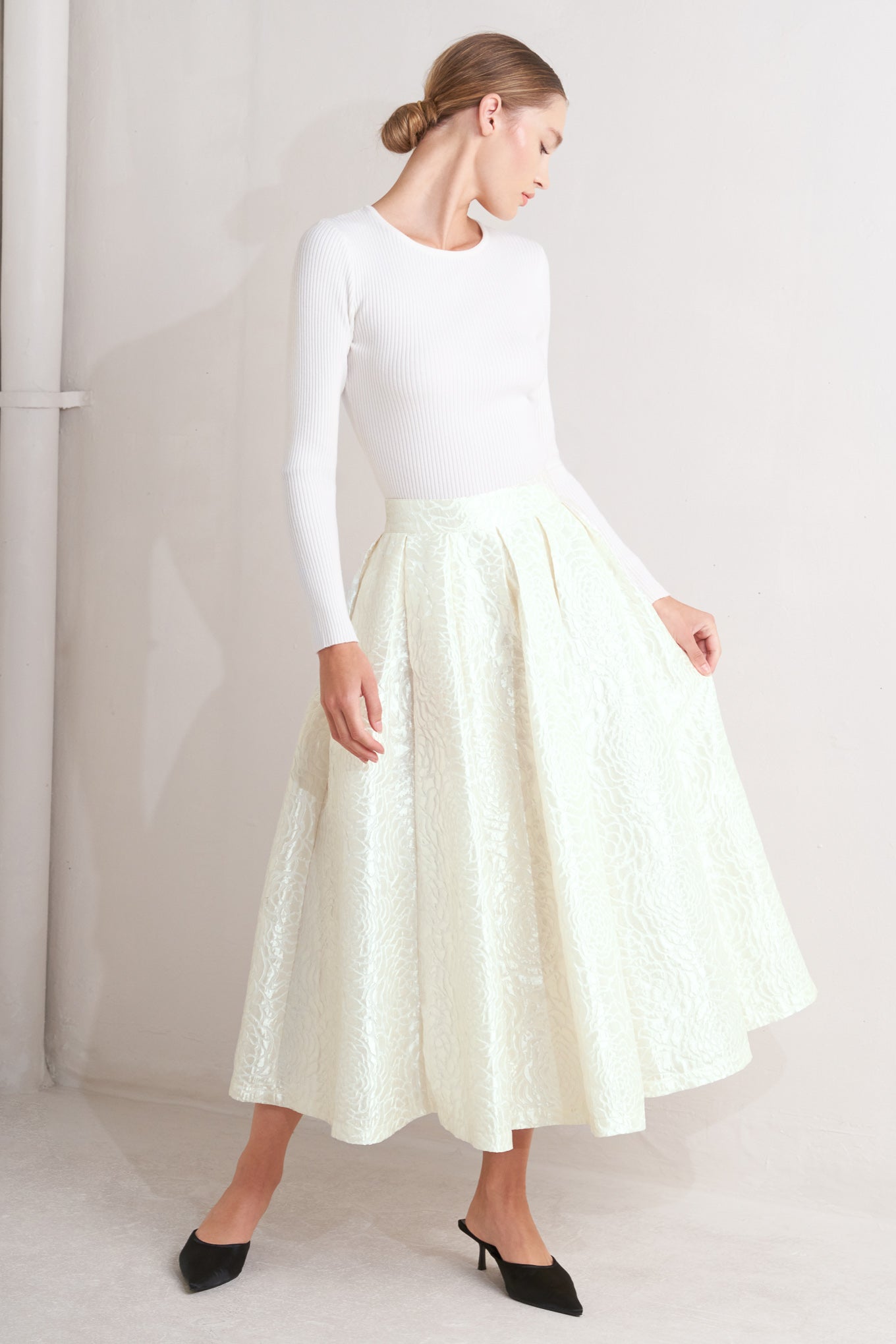 A textured woven full midi skirt with back zipper closure.