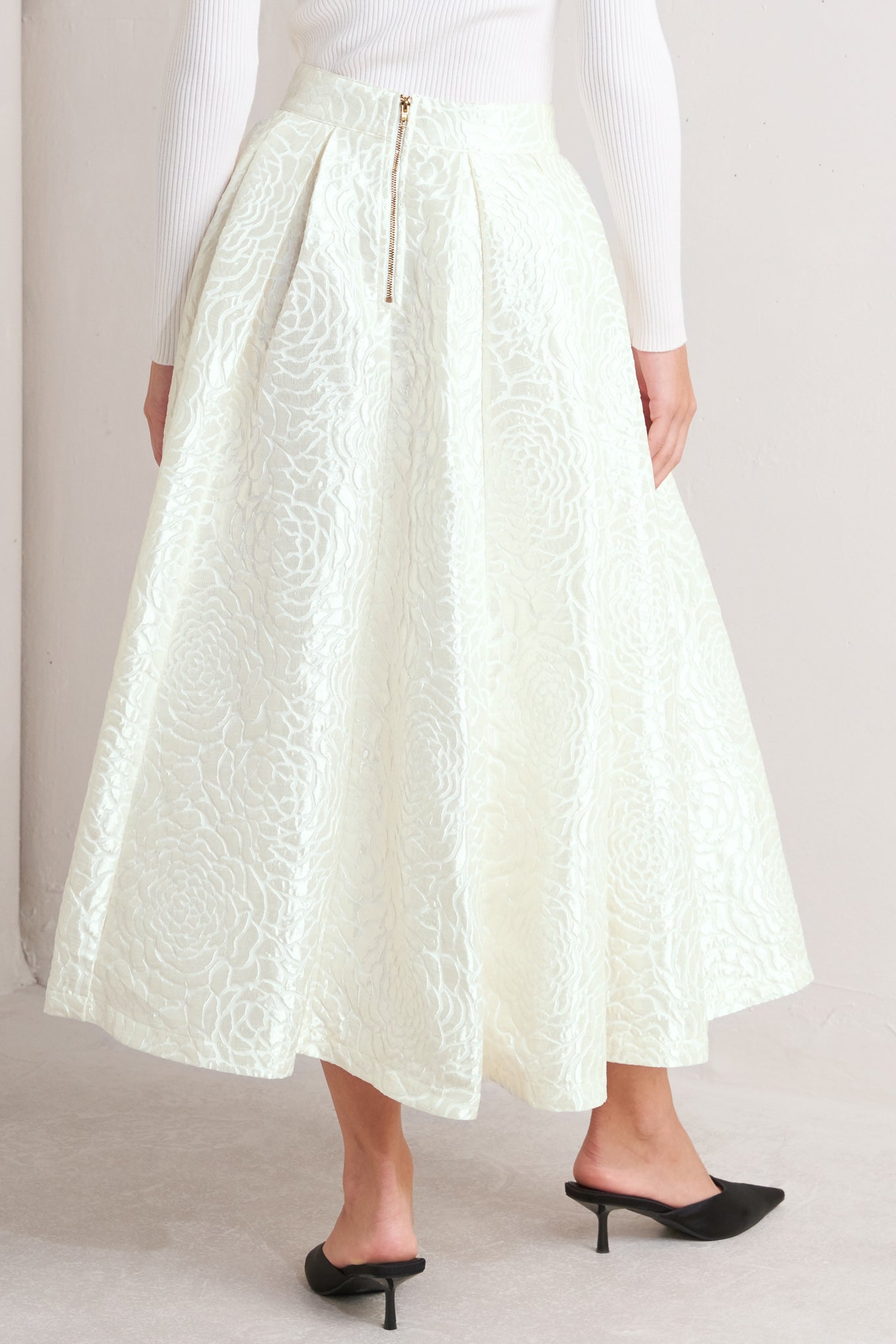 A textured woven full midi skirt with back zipper closure.